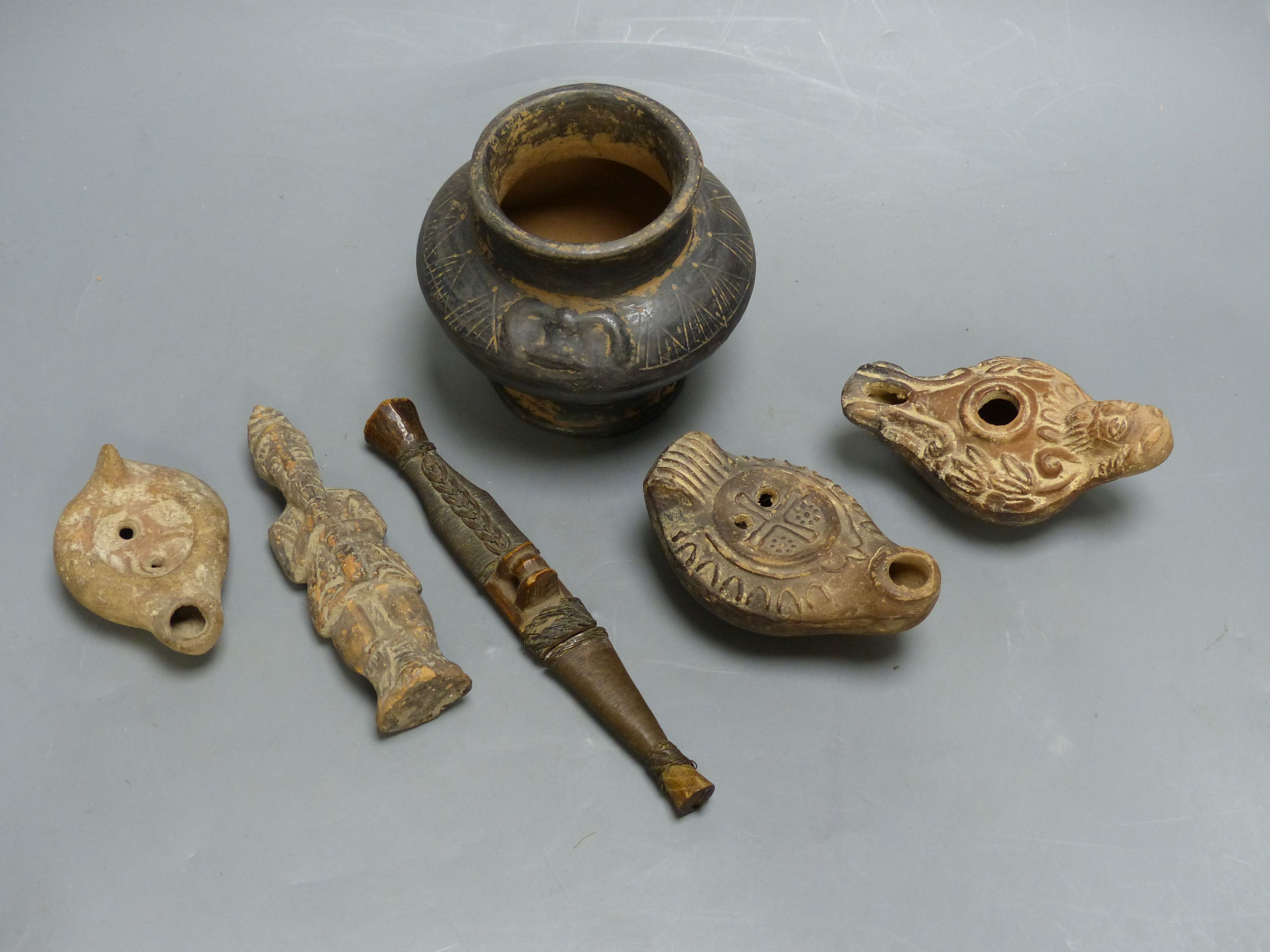 A group of antiquities, three oil lamps, a vase and a figure, etc.